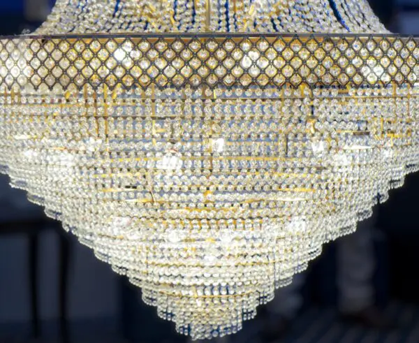 Elegant crystal chandelier with golden accents.