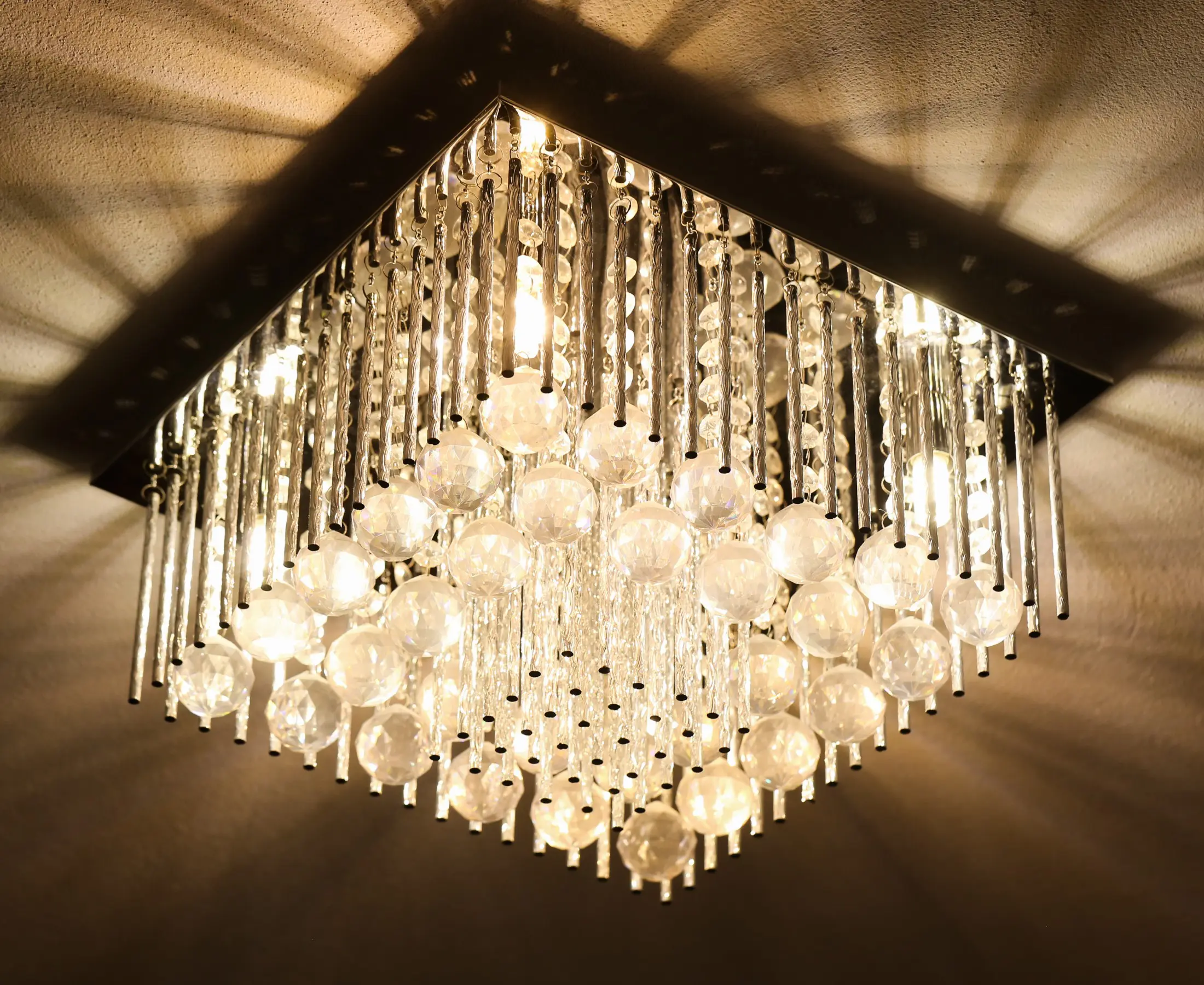 Crystal chandelier with cascading lights and reflections.